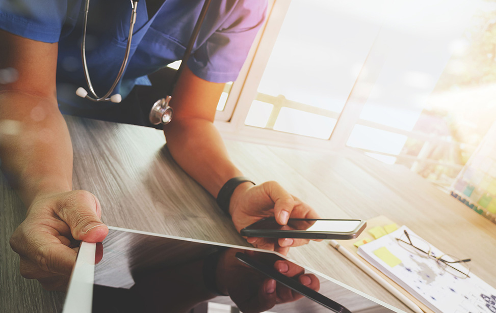 doctor holding phone and tablet